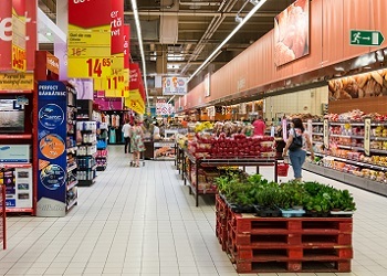 BUCHAREST, ROMANIA - AUGUST 10, 2014: People Shopping For Bread Products In Supermarket Store Aisle.